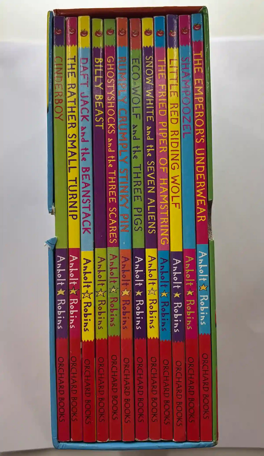 Set of children's books in a colourful box on a white background UK 